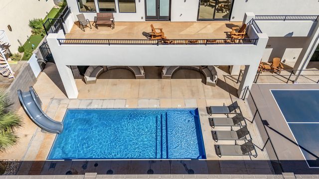 Aerial of private pool with slide and loungers at Pecan Valley 5193