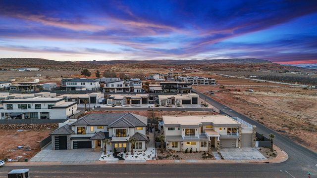 Aerial view of both Pecan Valley 5205/5193 Retreat homes at sunset