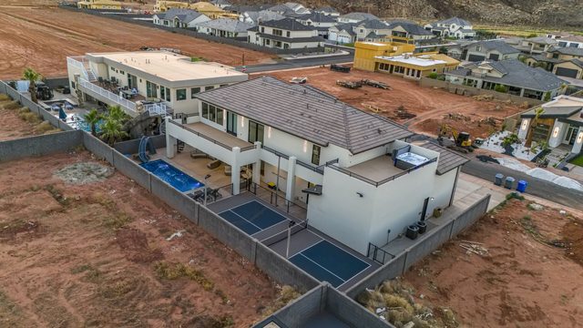 Aerial view of the 5193 home with backyard pool and pickleball court