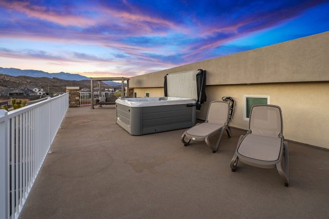 5205 upstairs balcony hot tub with loungers at sunset