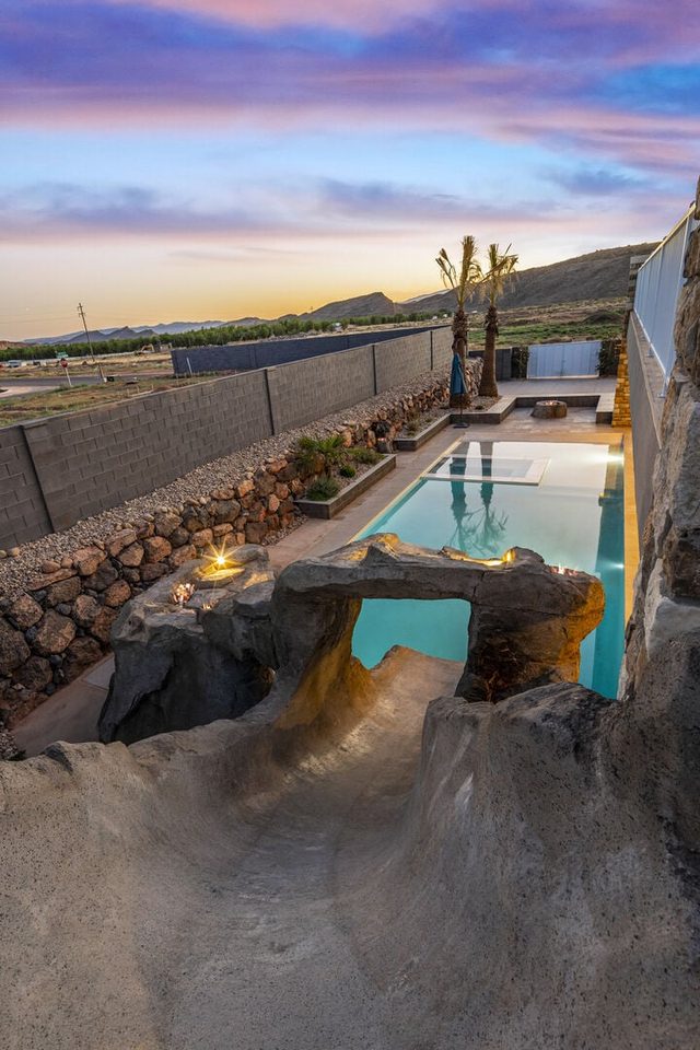 5205 private pool with rock slide and grotto at sunset