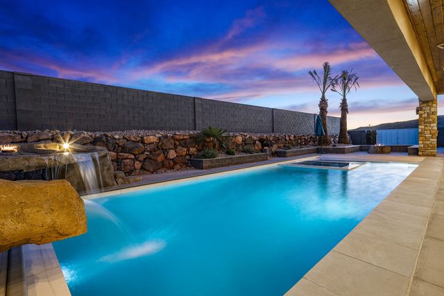 5205 private pool with waterfall and spa at dusk
