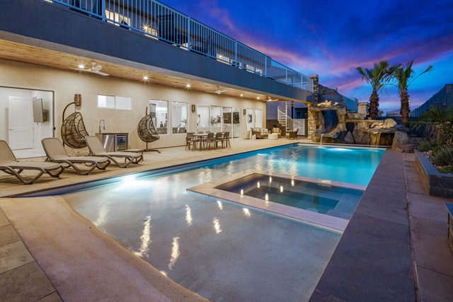 5205 private pool and spa with covered patio lit at dusk