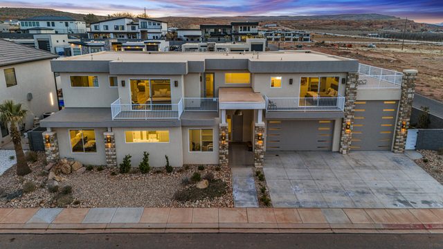 Front of Pecan Valley 5205 at dusk with two-car garage