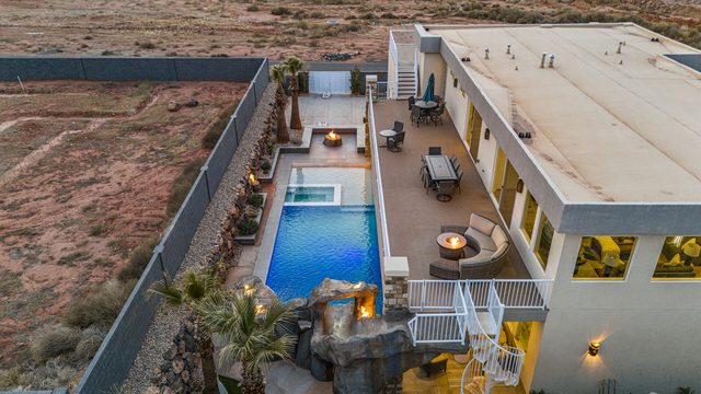 Aerial view of Pecan Valley 5205, pool and decks at dusk