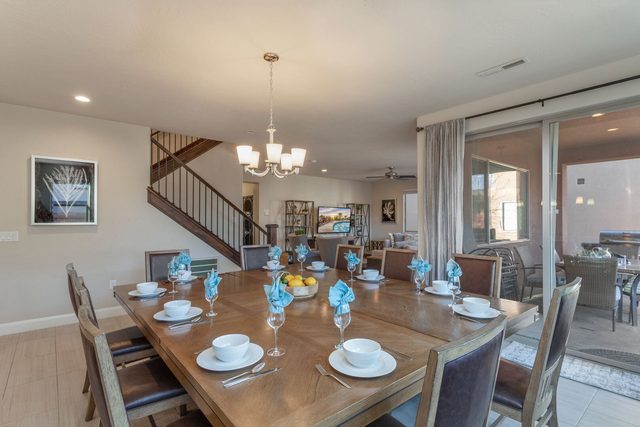 Unit 103 dining table set for ten beside patio doors