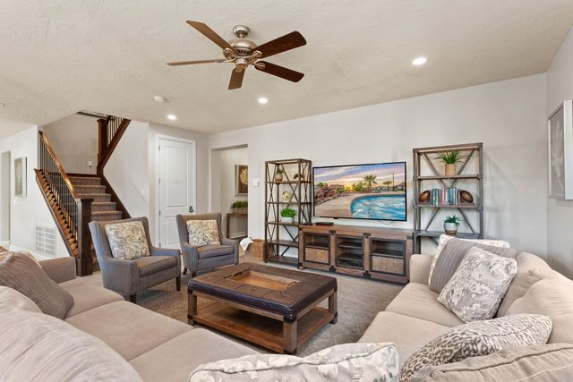 Unit 103 living room with sectional sofa and large TV