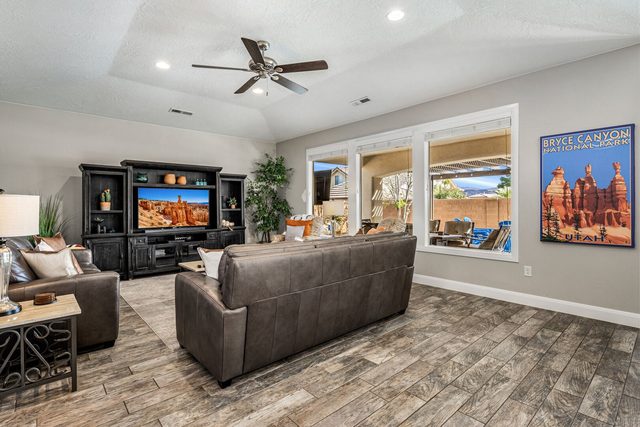 Family room entertainment center with TV and leather sofas