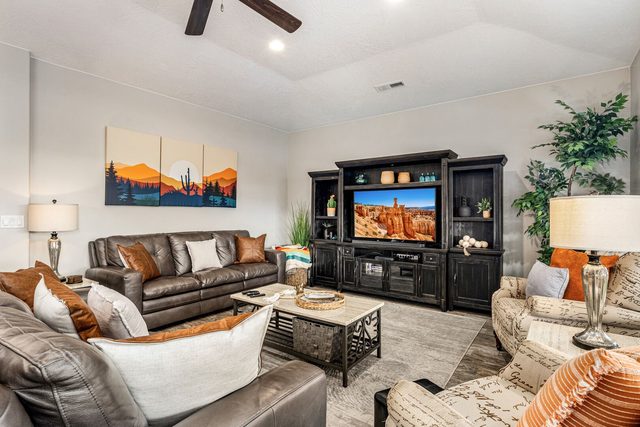 Leather sectional seating facing the TV and entertainment center