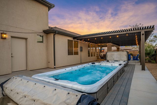 Private swim spa beside the covered patio at sunset