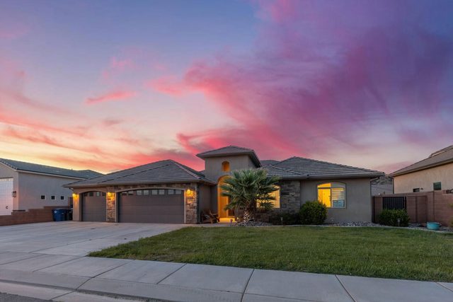 Sand Hollow 3334 front yard and garage under pink sky