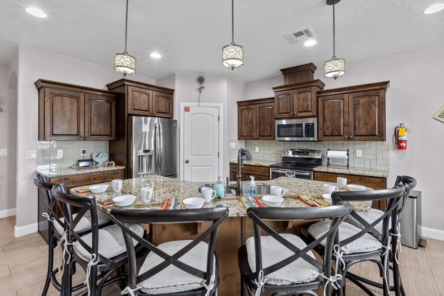 Kitchen island with seating and dark wood cabinets