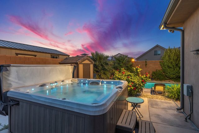 Private hot tub on the patio beside the pool