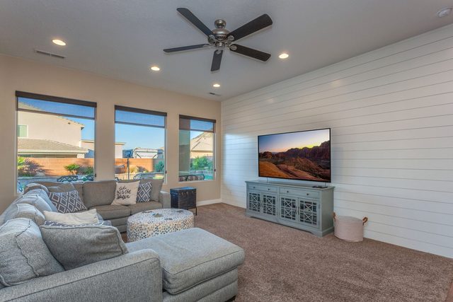 Living room sectional facing TV on white shiplap wall