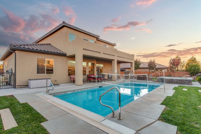 Rear exterior of Sand Hollow 3370 with private pool at sunset