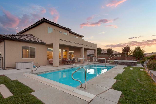 Private pool and covered patio at sunset