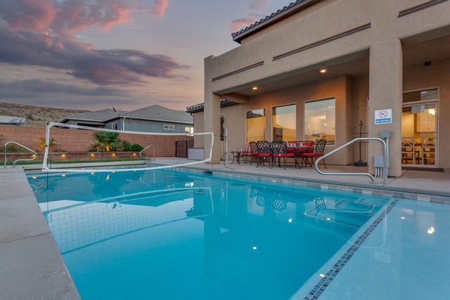 Private pool with volleyball net beside covered patio at Sand Hollow 3370