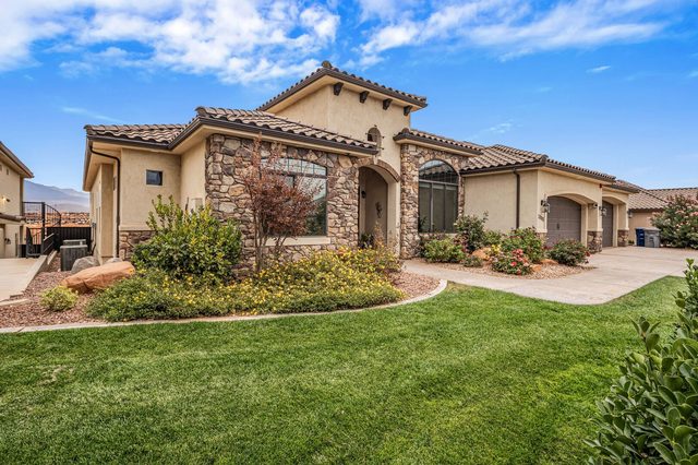 Front exterior with stone accents and landscaped lawn