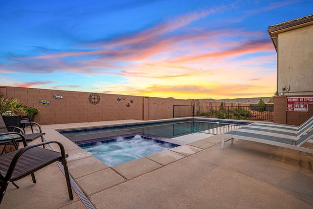 Private spa with jets at sunset beside the pool