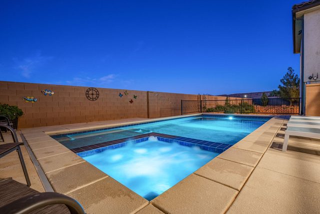 Lit private spa and pool in the evening