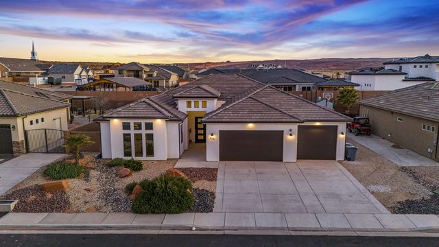 Front of the home with garages at sunset at Sand Hollow 4301