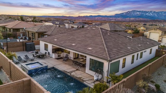 Aerial of the home and backyard pool with mountains at Sand Hollow 4301