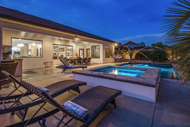 Private pool and raised hot tub at dusk at Sand Hollow 4301