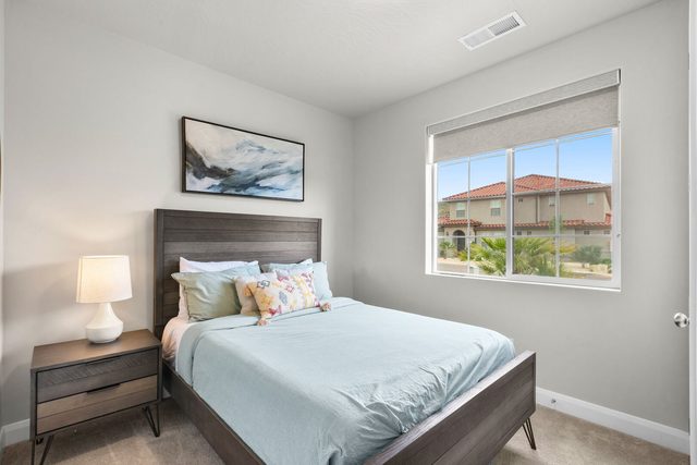 Downstairs queen bedroom with light blue bedding in home 2311