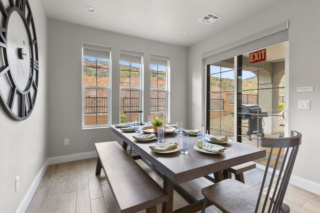 Dining table with bench seating beside patio door in home 2311