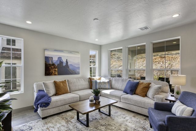 Home 2323 living room with large sectional sofa and canyon art