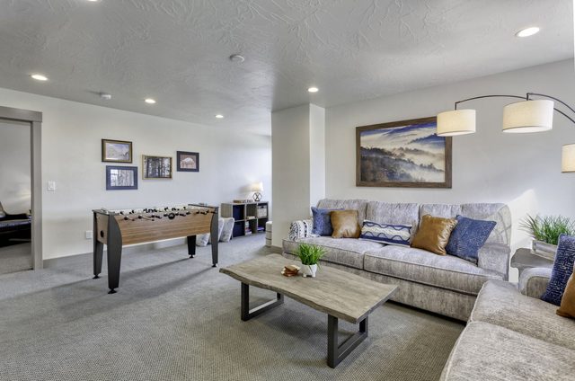 Upstairs loft lounge with sectional sofa and foosball table in home 2323