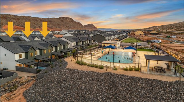 Aerial of the three Skyline Retreat homes near the community pool at sunset