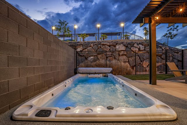 Skyline 1622 private swim spa lit at dusk