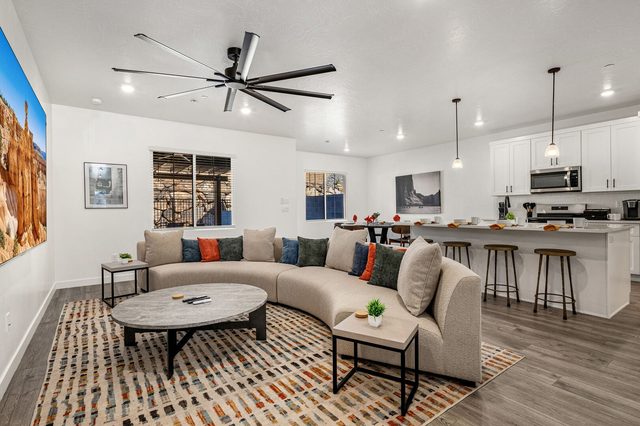 Open living room with sectional looking toward the kitchen island