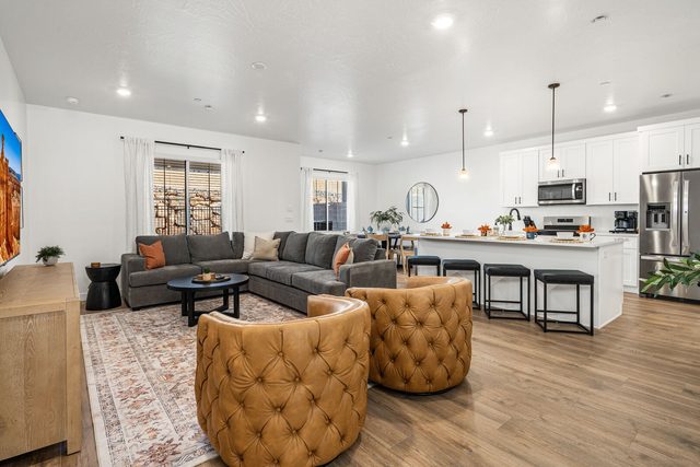 Open living room with swivel chairs and kitchen beyond at Skyline 1634