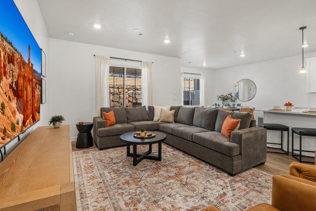 Living room sectional and large TV at Skyline 1634