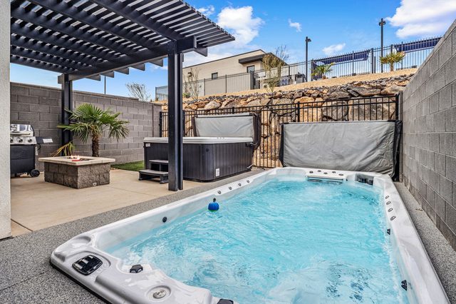 Heated swim spa with hot tub and fire pit at Skyline 1634