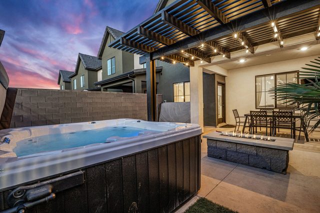 Swim spa next to the pergola and fire pit at Skyline 1634