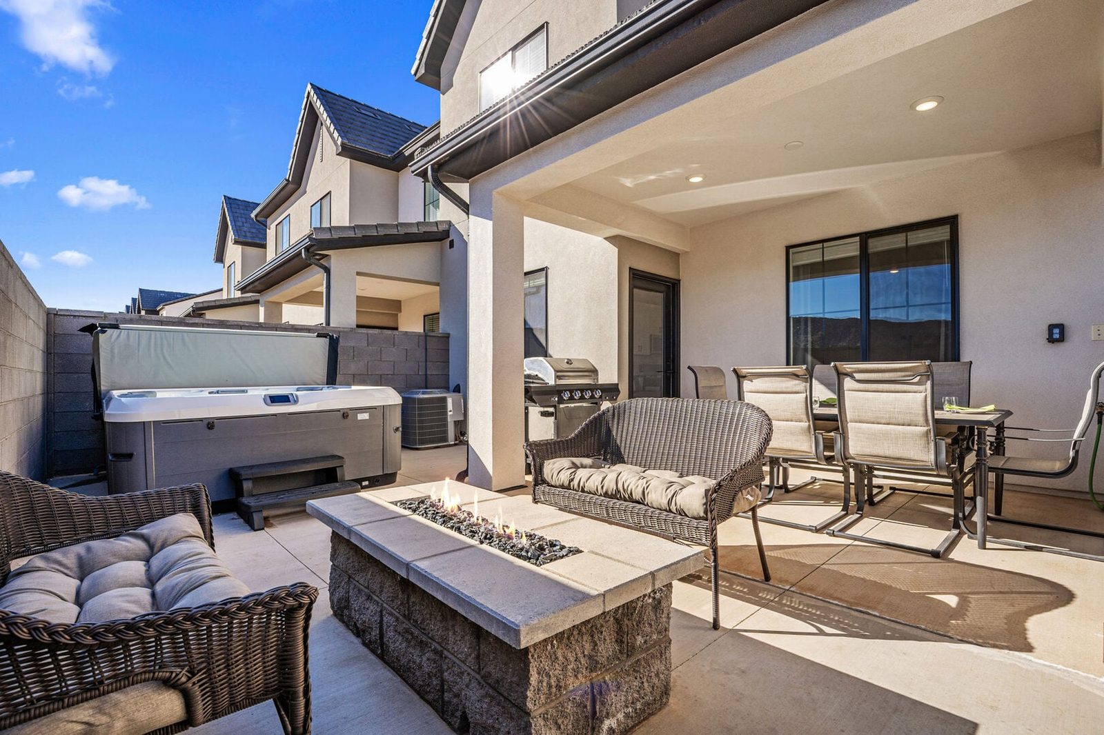 Private back patio with hot tub and fire pit at Skyline 1645