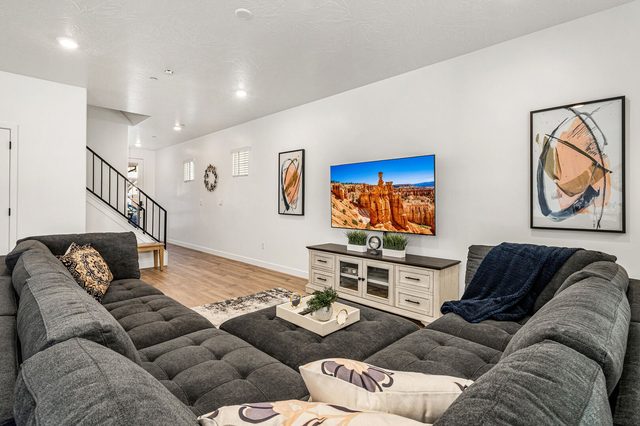 Living room with large sectional sofa and wall-mounted TV