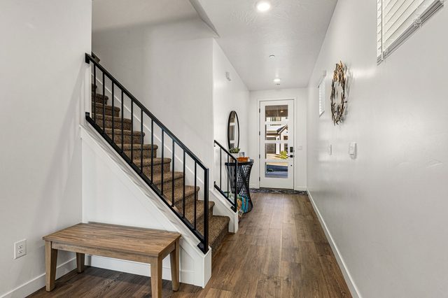 Entry hallway with staircase and bench at Skyline 1645