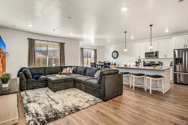 Open living area with sectional sofa facing the kitchen island
