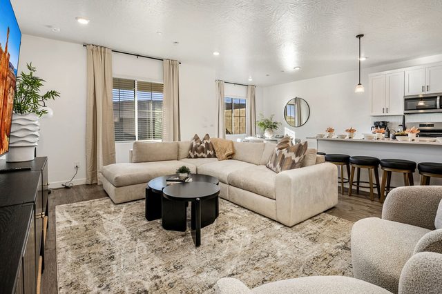 Living room sectional and round coffee tables at Skyline 1649