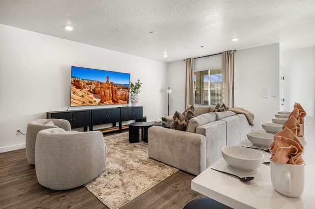 Living room swivel chairs facing a large TV at Skyline 1649