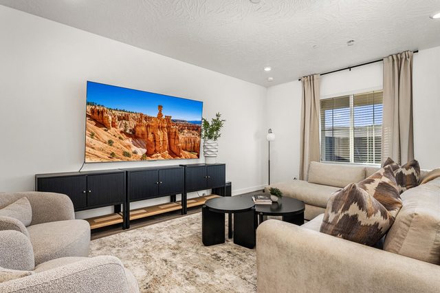 Living room media console and wall-mounted TV at Skyline 1649