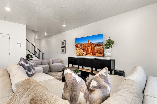 Living room TV wall beside the staircase at Skyline 1649