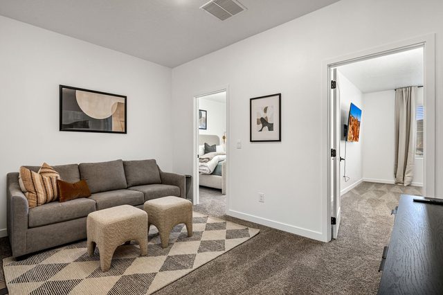 Upstairs loft with sofa and ottomans at Skyline 1649