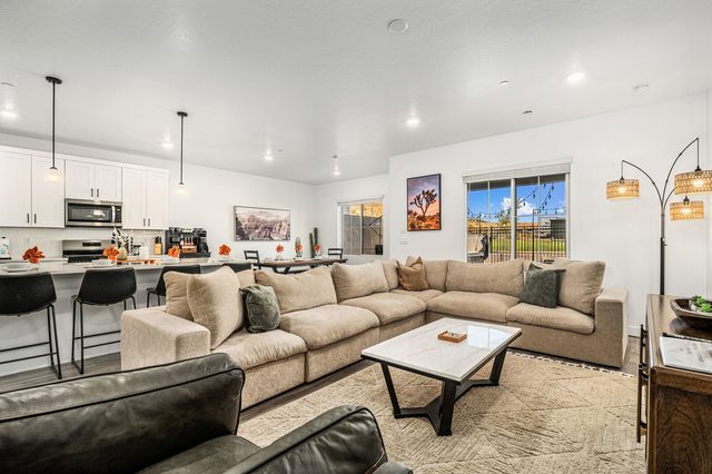 Living room with large sectional, coffee table and leather chairs