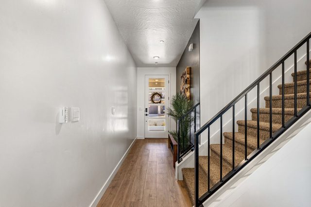 Main floor hallway with staircase to the upstairs loft