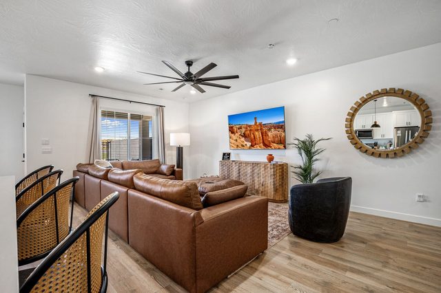 Living room seating with smart TV and round mirror